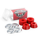 A set of four Indy Standard Cylinder Cushions Soft 88A Red skateboard bushings with four silver washers, shown in an open transparent box labeled INDEPENDENT PARTS 88 SOFT against a red background.