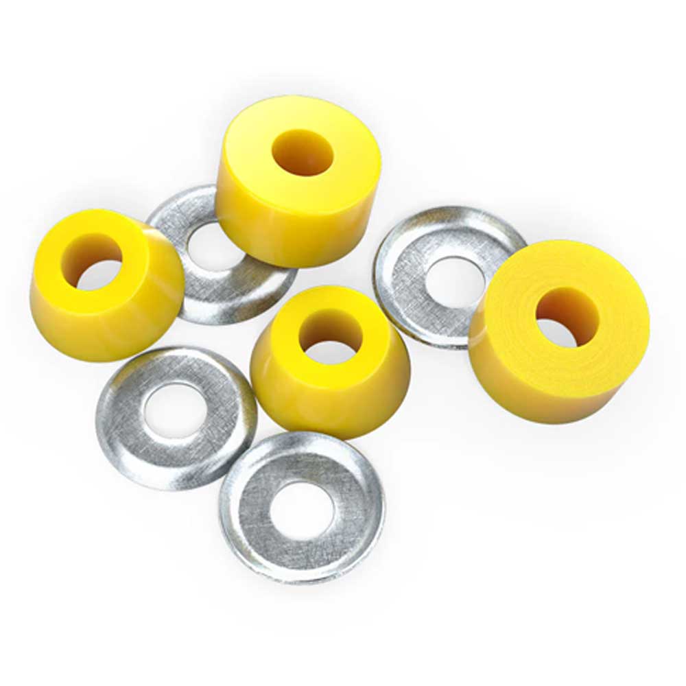 Four Indy Standard Cylinder Cushions Super Hard 96A Yellow skateboard bushings with center holes are arranged next to four silver washers on a white background.