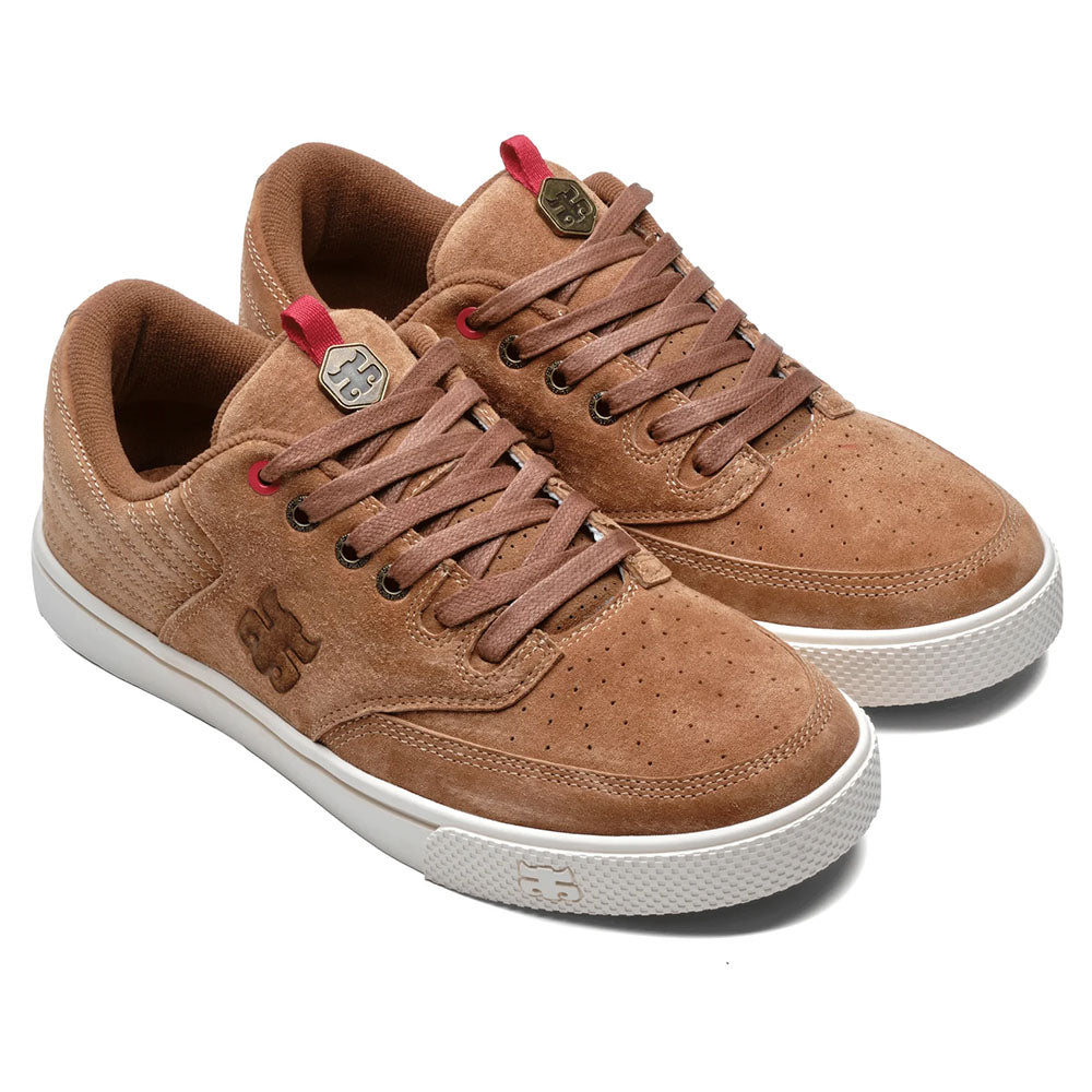 The Poet Suede Brown Suede I Path Shoes feature brown suede, red eyelets, white rubber soles, matching laces, and a metallic logo—ideal for anyone seeking classic style with a modern edge for skateboarding or everyday wear.