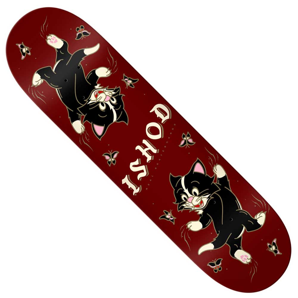 The Ishod Kitten Scratch 8.25 Twin Tail from Real Skateboards features a vibrant red deck adorned with two playful cartoon black cats sporting white paws and faces, surrounded by delicate flowers and stars. Bold white “ISHOD” lettering stands out at the center, perfectly embodying the whimsical charm of the Ishod Kitten Scratch series.