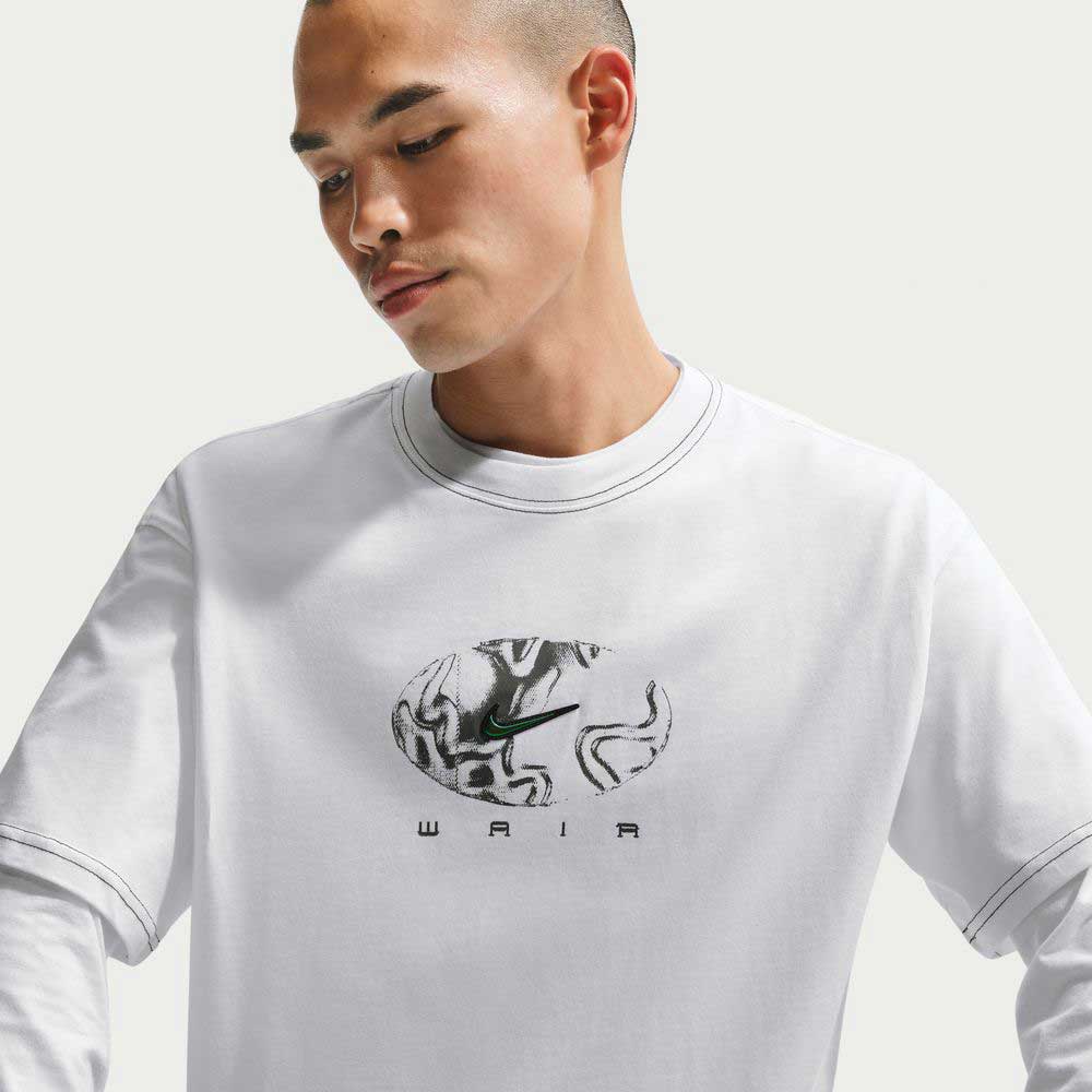 Wearing the Ishod Tee White IH1437100 Nike SB T-Shirt—midweight cotton, black and green oval logo with "WAIR" below—a person looks downward with a neutral expression against a plain background.