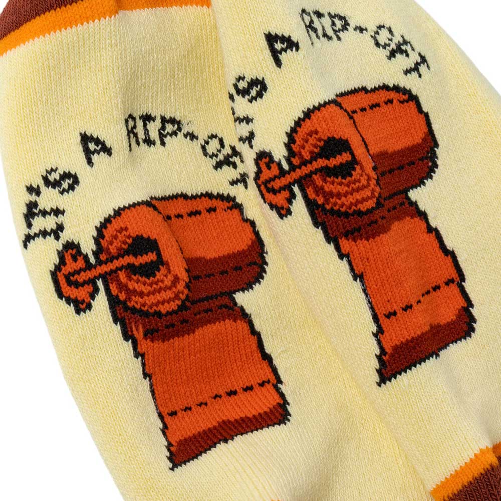 The Its a Rip Off Cream Anti Hero Skateboards Socks feature a playful orange cartoon toilet paper roll and the phrase “IT’S A RIP-OFF” printed above in bold black text, bringing a touch of irreverent Anti Hero Skateboards style to your everyday look.