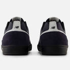 Rear view of Jamie Foy Eclipse White 306 NSN New Balance Numeric suede skateboarding shoes in navy blue and black with white heel accents, New Balance logo on each heel tab, set against a plain white background.