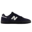 The Jamie Foy Eclipse White 306 NSN New Balance Numeric Suede Skateboarding Shoe features a sleek navy blue suede upper with a white N logo on the side, complemented by black laces and a black sole. Shown in side profile on a white background, this stylish vulcanized skate shoe draws inspiration from the Jamie Foy pro model.