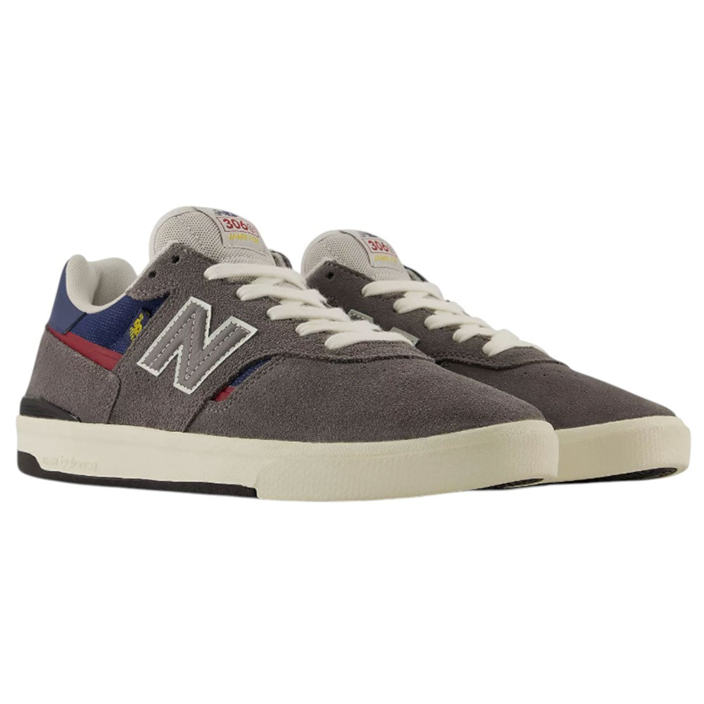 A pair of Jamie Foy Cup 306 CON New Balance Numeric Suede Skateboarding Shoes, featuring gray durable suede, white soles with a rubber cup outsole, cream laces, red and blue accents, and the signature N logo on the sides.