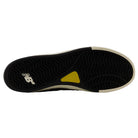 The image features the black rubber outsole of the Jamie Foy Cup 306 CON New Balance Numeric Suede Skateboarding Shoe, showcasing its yellow accent and white NB logo, as well as the impact protection typical of Jamie Foy’s skate shoes.
