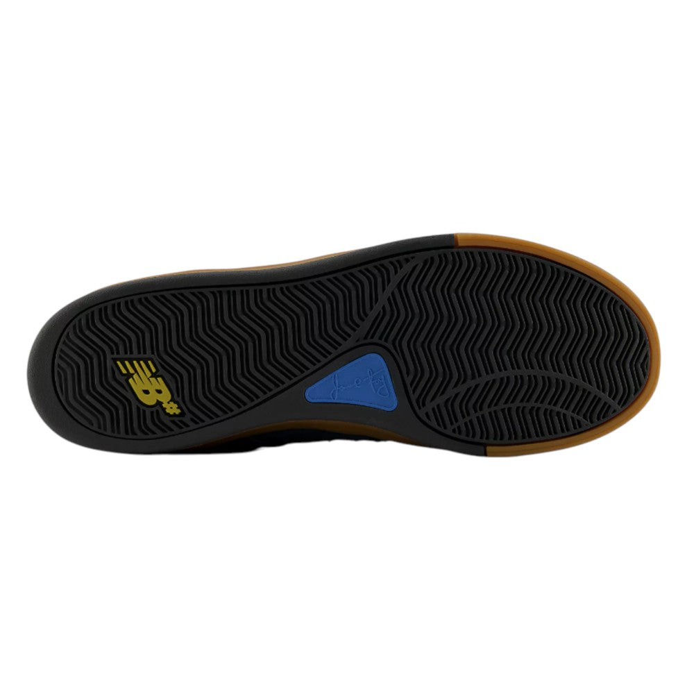 Black Jamie Foy Cup 306 CON New Balance Numeric suede skateboarding shoe outsole with a gum rubber perimeter, yellow logo, and blue inlay featuring a signature.