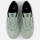 A top view of the Mosaic Green Black Jamie Foy Mint 306 MOG New Balance Numeric suede skateboarding shoes with white laces, black interior lining, "JAMIE FOY 306" on the tongue, and hexagonal insole branding.