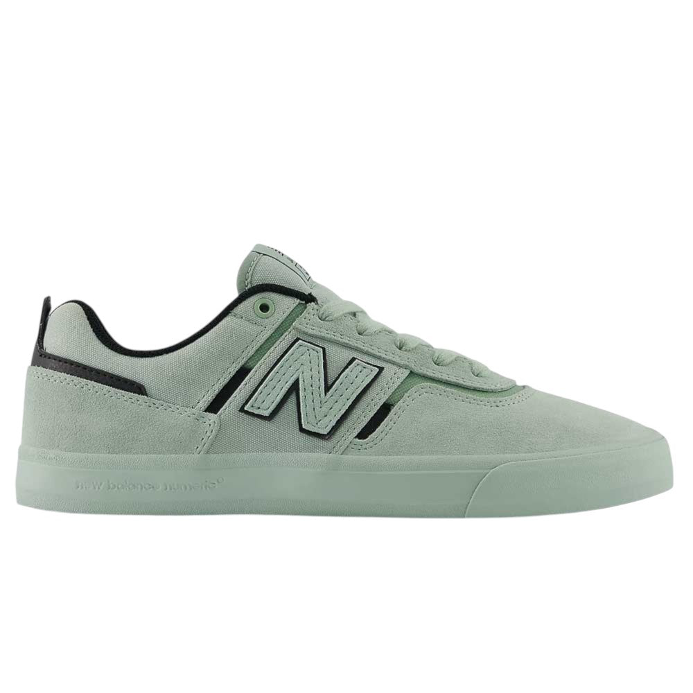 The Mosaic Green Black Jamie Foy Mint 306 MOG New Balance Numeric Suede Skateboarding Shoes are shown in a side view against a white background, featuring light green suede uppers with black accents, a white and black “N” logo on the side, and a matching green rubber sole. This Jamie Foy pro model combines the durability of a vulcanized skate shoe with standout performance and style.