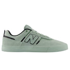 The Mosaic Green Black Jamie Foy Mint 306 MOG New Balance Numeric Suede Skateboarding Shoes are shown in a side view against a white background, featuring light green suede uppers with black accents, a white and black “N” logo on the side, and a matching green rubber sole. This Jamie Foy pro model combines the durability of a vulcanized skate shoe with standout performance and style.
