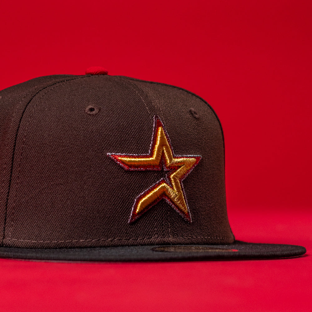The KB2 OG Wood Black The Original Houston Astros New Era Hat 5950 Fitted features a gold and red outlined star emblem on the front, representing the Astros, all set against a bold black background.