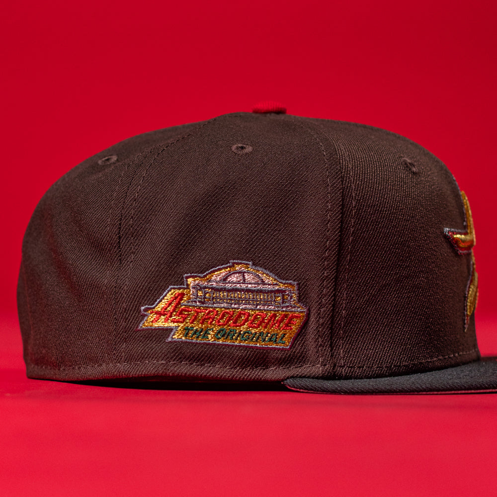 The KB2 OG Wood Black The Original Houston Astros New Era Hat 5950 Fitted features a flat brim and a colorful "Astrodome The Original" side patch. Perfect for Astros fans, shown against a bold red background.