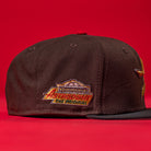 The KB2 OG Wood Black The Original Houston Astros New Era Hat 5950 Fitted features a flat brim and a colorful "Astrodome The Original" side patch. Perfect for Astros fans, shown against a bold red background.