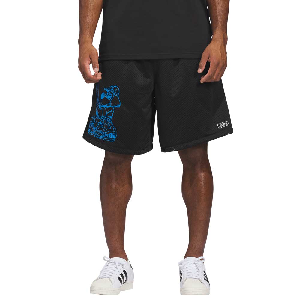 A person wearing KC6308 Kogan Shorts Blue Black Adidas Skateboarding, featuring a blue left-leg graphic, paired with a black shirt and white Adidas sneakers. The photo is cropped from the shoulders down.