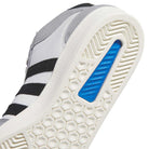 Close-up of the sole on KJ5031 Adidas Superskate Gray Black Skateboarding Shoes, featuring a hexagonal tread pattern, black side stripes, and a blue heel insert—classic style and ideal for skateboarding.
