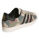 The KJ5120 Camouflage Black Superstar ADV Adidas Skateboarding Suede Shoes feature a camouflage pattern, black stripes, gold Superstar text, white sole, and a black heel patch with gold adidas Originals logo—ideal for skate shoe fans.