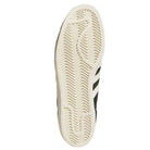 The image shows the off-white sole of the KK5003 Black White Superstar 80 ADV Adidas Skateboarding Leather Shoes, featuring a herringbone tread. Part of the black leather upper with white stripes is also visible along the sides.