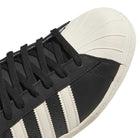 Close-up of KK5003 Black White Superstar 80 ADV Adidas Skateboarding Leather Shoes, featuring white stripes and a textured rubber toe cap—an iconic choice for skaters.