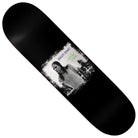 The Kevin Spanky Long Spanky Jr. 8.25 Baker Skateboards Deck features a black-and-white photo of Kevin “Spanky” Long standing outdoors, with “Baker Brand” and “Kevin Long” written above the image in vibrant purple and green text. This 8.25″ deck is perfect for fans of classic style and performance.