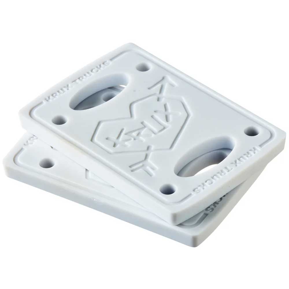 Two white Krux 1/4 Inch Riser Pads, each with four corner holes and a geometric heart design plus "KALT" and "KALT TRUCKS" text—ideal as stylish, versatile alternatives to standard riser pads. Set includes one pair.