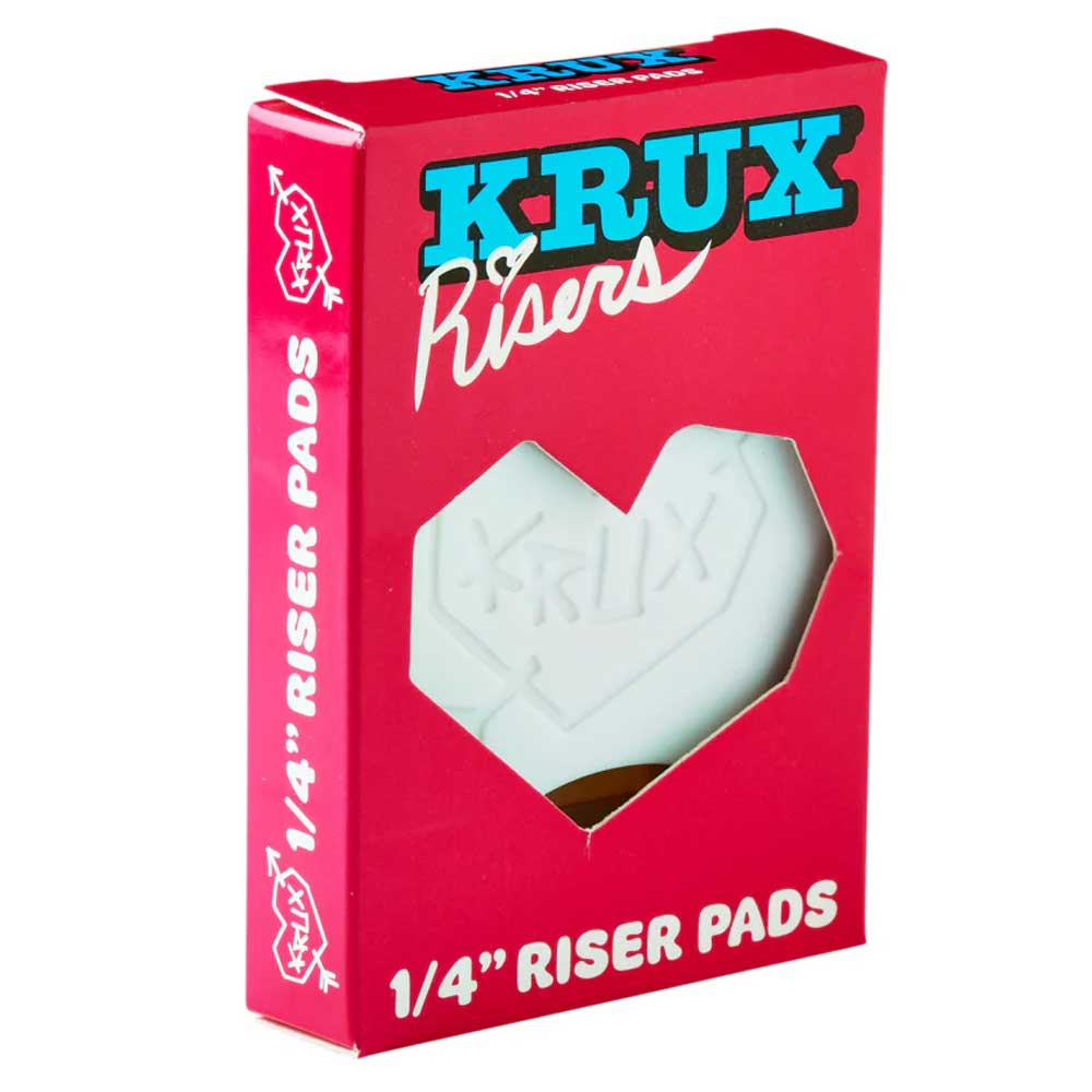 A red box labeled "KRUX Risers" with a heart-shaped cutout displays the white Krux 1/4 Inch Riser Pad Set Pair inside, ideal for adding risers to your skateboard’s Krux Trucks setup.