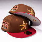 Two Bendicion de la Abuela 20th Brown Red Houston Astros New Era Hat 5950 Fitted hats, with a gold star and 20 YEARS patch, are stacked on a white background.