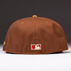 A Bendicion de la Abuela 20th Brown Red Houston Astros New Era Hat 5950 Fitted viewed from the back, featuring the MLB logo patch near the bottom edge of this classic cap.