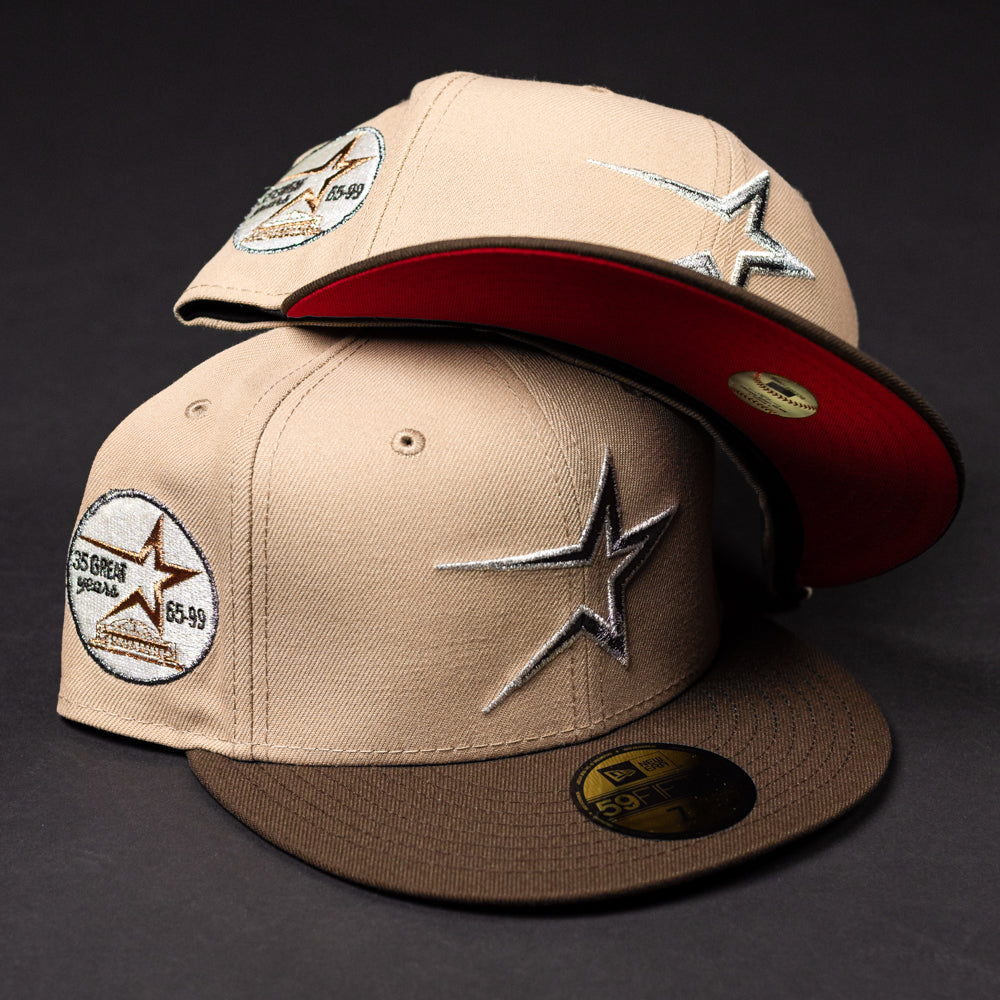Two La Playa Roja 35th Red Camel Houston Astros New Era Hat 5950 Fitted caps, featuring star logos and round "65.99 Great Somalia" patches—one shows a red underbrim—are stacked against a dark background in classic New Era style.