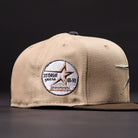 The La Playa Roja 35th Red Camel Houston Astros New Era Hat 5950 Fitted has a circular patch with a gold star, "35 Great Years," and the years '65-'99 on the side. The background is black.