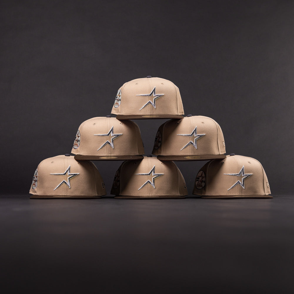Five La Playa Roja 35th Red Camel Houston Astros New Era 5950 Fitted hats are arranged in a pyramid shape against a dark background.