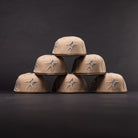 Five La Playa Roja 35th Red Camel Houston Astros New Era 5950 Fitted hats are arranged in a pyramid shape against a dark background.