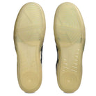 The Leggerezza Asics Oyster Grey Black 1203B087 020 Suede Skateboarding Shoes feature translucent light yellow rubber soles with circular and linear grip patterns, plus a breathable mesh design for added comfort.