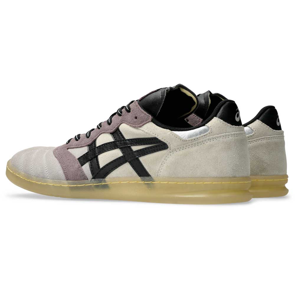 The Leggerezza Asics Oyster Grey Black 1203B087 020 features beige suede uppers, black Asics stripes, purple-gray accents, black tongues, and translucent gum soles for a soccer-inspired look, visible from both sides in this angle.