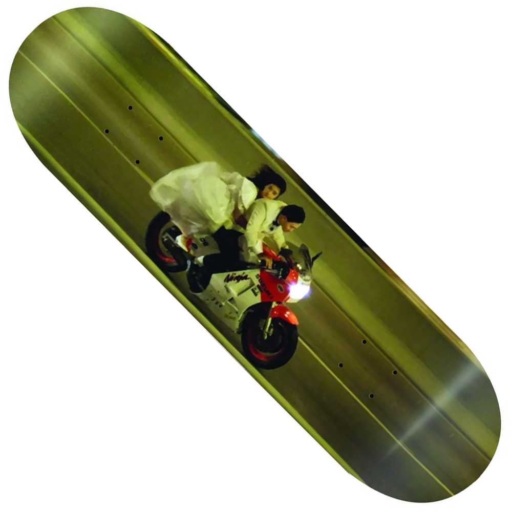 The Lester Romance 8.25 Sci-Fi Fantasy Skateboards Deck showcases a man and woman in white formal wear riding a red and white motorcycle at night—an adventurous and stylish design.