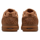 Two Light British Tan Paul Rodriguez Zoom Air Low Suede Skateboarding shoes are shown from the back, highlighting their quilted texture, stitched Nike logos on the heels, and durable rubber outsoles.