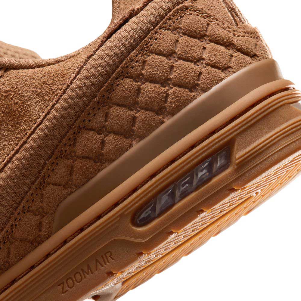 Close-up of the heel of the Light British Tan IQ6827200 Paul Rodriguez Zoom Air Low Suede Skateboarding Shoe, showcasing its textured brown suede material, premium leather upper, and visible air cushion embedded in the sole with “ZOOM AIR” embossed on the midsole. The design is finished with a durable rubber outsole for enhanced traction.
