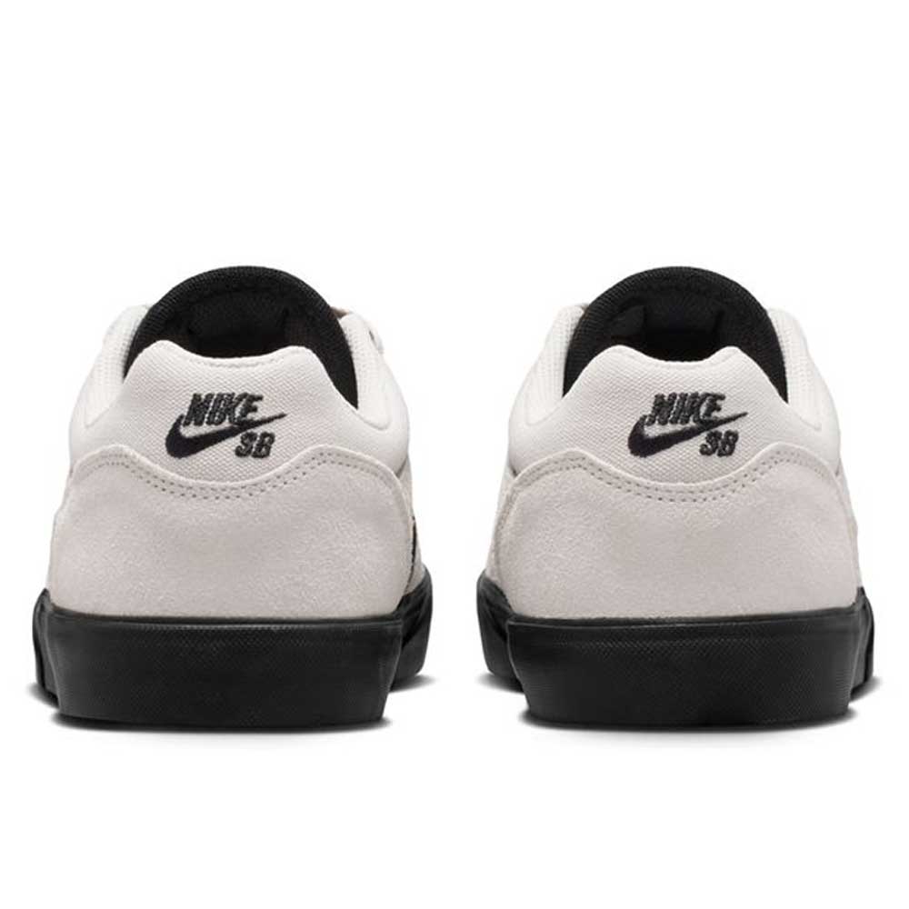Back view of Light Orewood FV6064104 Malor Nike SB shoes with white uppers, black soles, black Nike SB heel logos, and black inner lining. Durable skate sneakers are placed side by side on a white background.