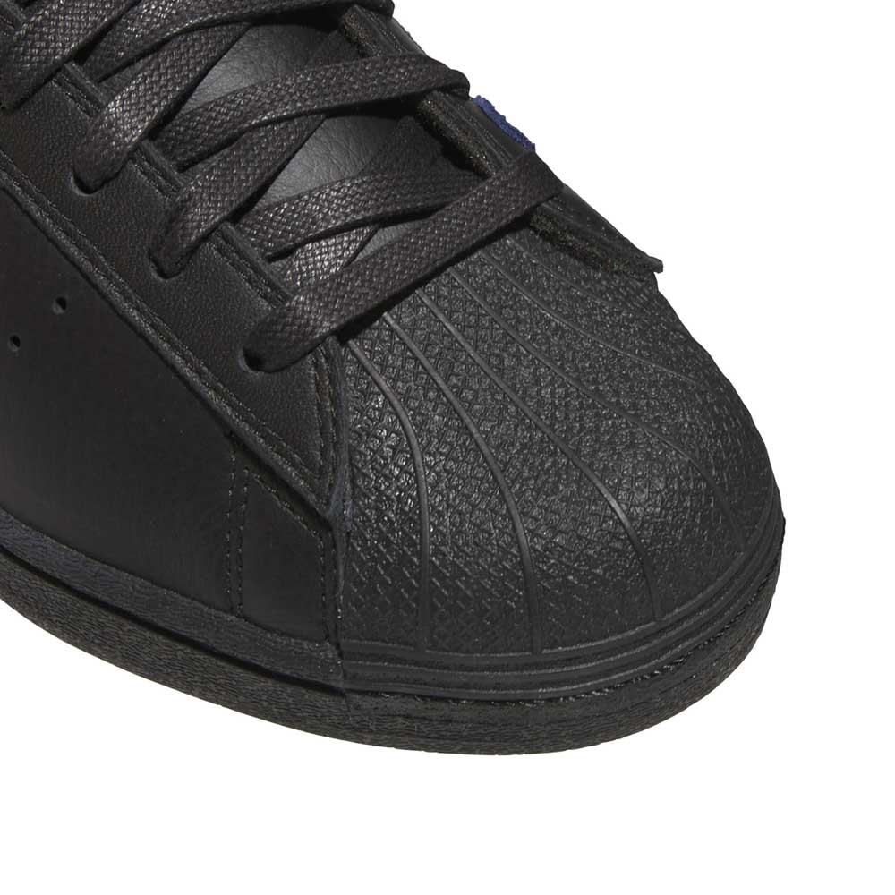 Close-up of the toe area of the Mark Gonzales Black Black Black LA6416 Superstar ADV x Gonz Adidas Skateboarding Leather Shoes Footwear, featuring a textured rubber shell and black laces, showcasing the classic design inspired by skateboarding shoes.