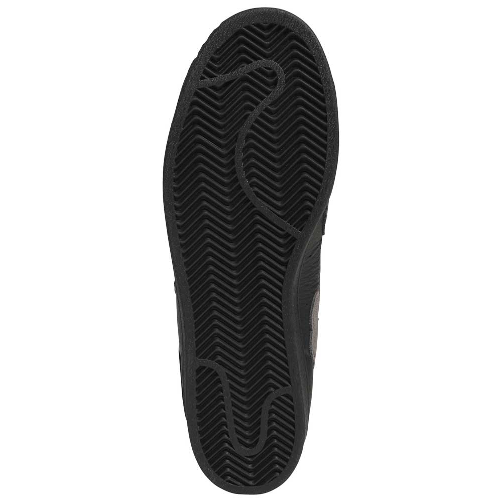 The image shows the black rubber sole of the Mark Gonzales Black Black Black LA6416 Superstar ADV x Gonz Adidas Skateboarding Leather Shoes, featuring a herringbone tread pattern and textured grooves, viewed from the bottom against a white background—a classic design element of this adidas Skateboarding collaboration.