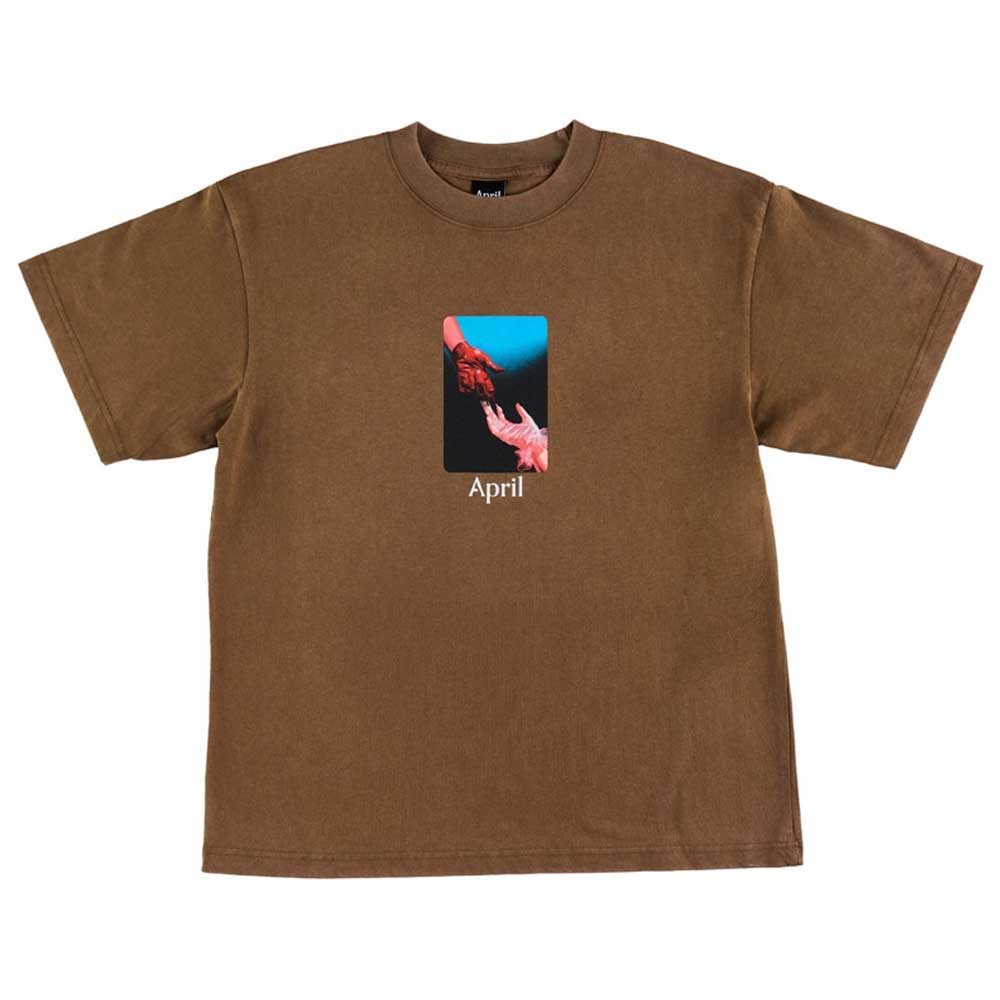 The Material Tee Washed Brown April Skateboards T-Shirt is a 100% cotton heavyweight tee, garment dyed for a unique finish, featuring two hands—one red, one white—reaching on a blue and black backdrop with "April" below.