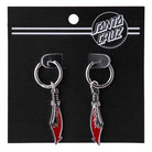 The Meek Slasher Sword Earring Set features two silver skateboard earrings with red and silver knife charms, displayed on a black "Santa Cruz" card, inspired by the iconic Slasher graphic.