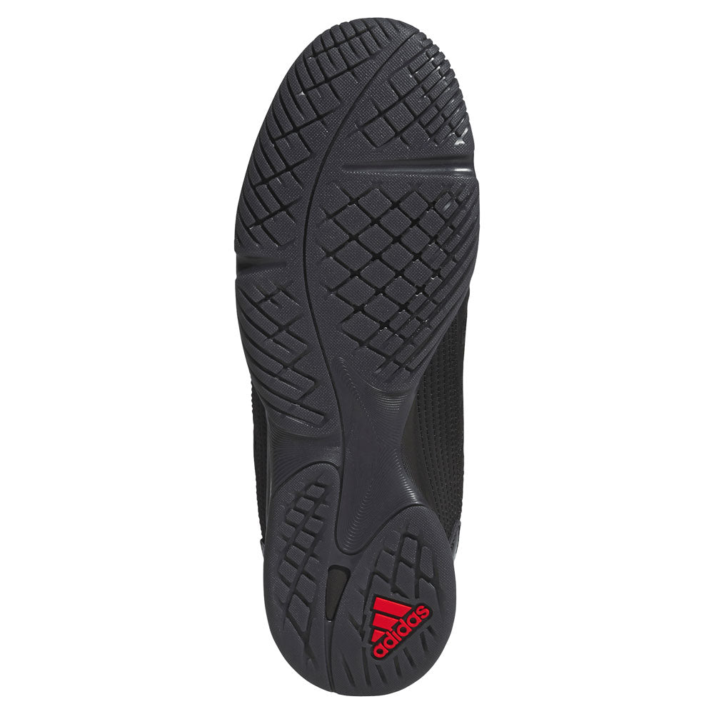 Black athletic shoe sole with deep treads and textured grip patterns; the Adidas logo appears in red near the heel, reflecting the Metalwood Predator Sala HP4953 Black Adidas Skateboarding Shoes.