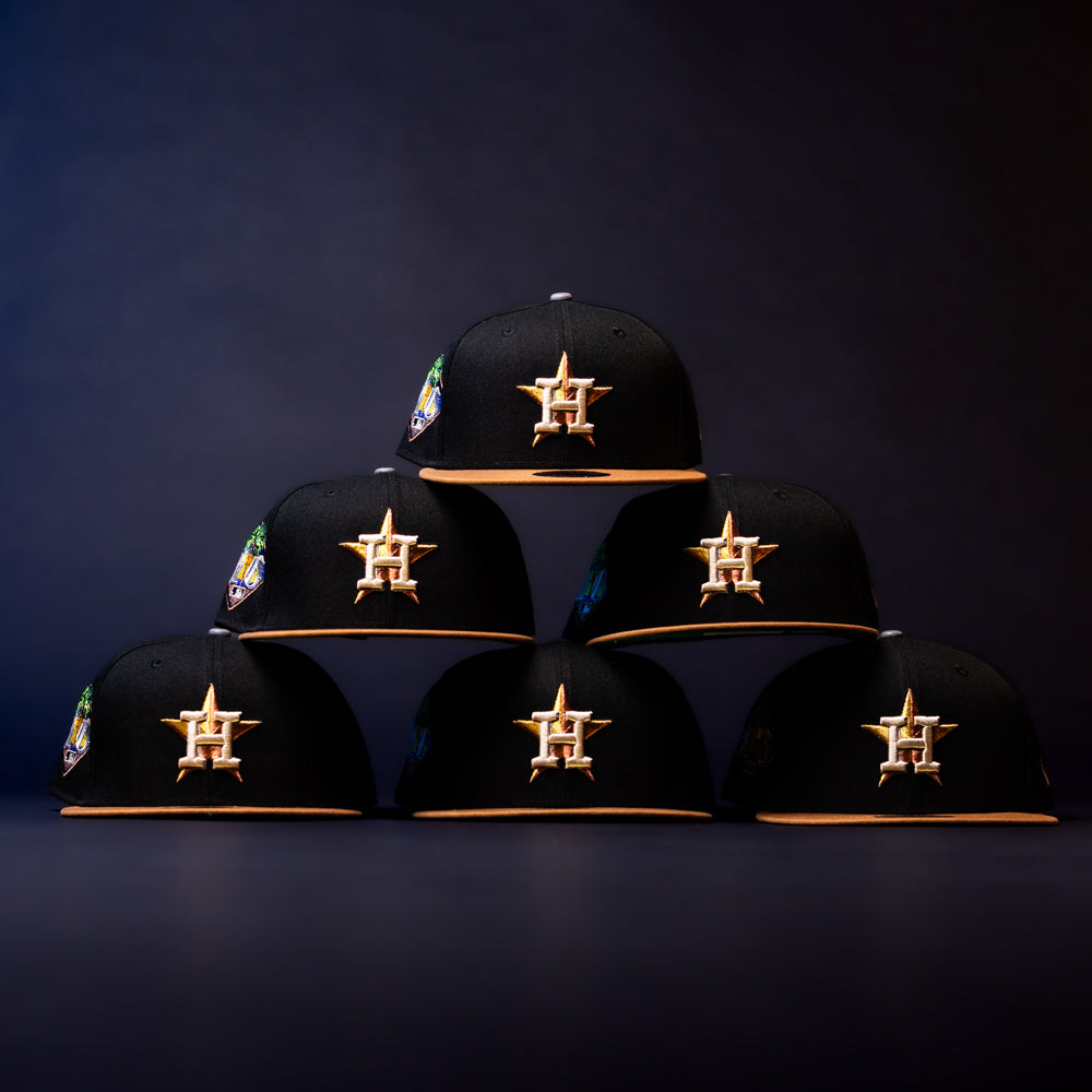 Six Midsummer Night 26 Spring Bronze Houston Astros New Era 5950 Fitted hats with gold logos, yellow brims, and side patches are arranged in a pyramid formation against a dark background.