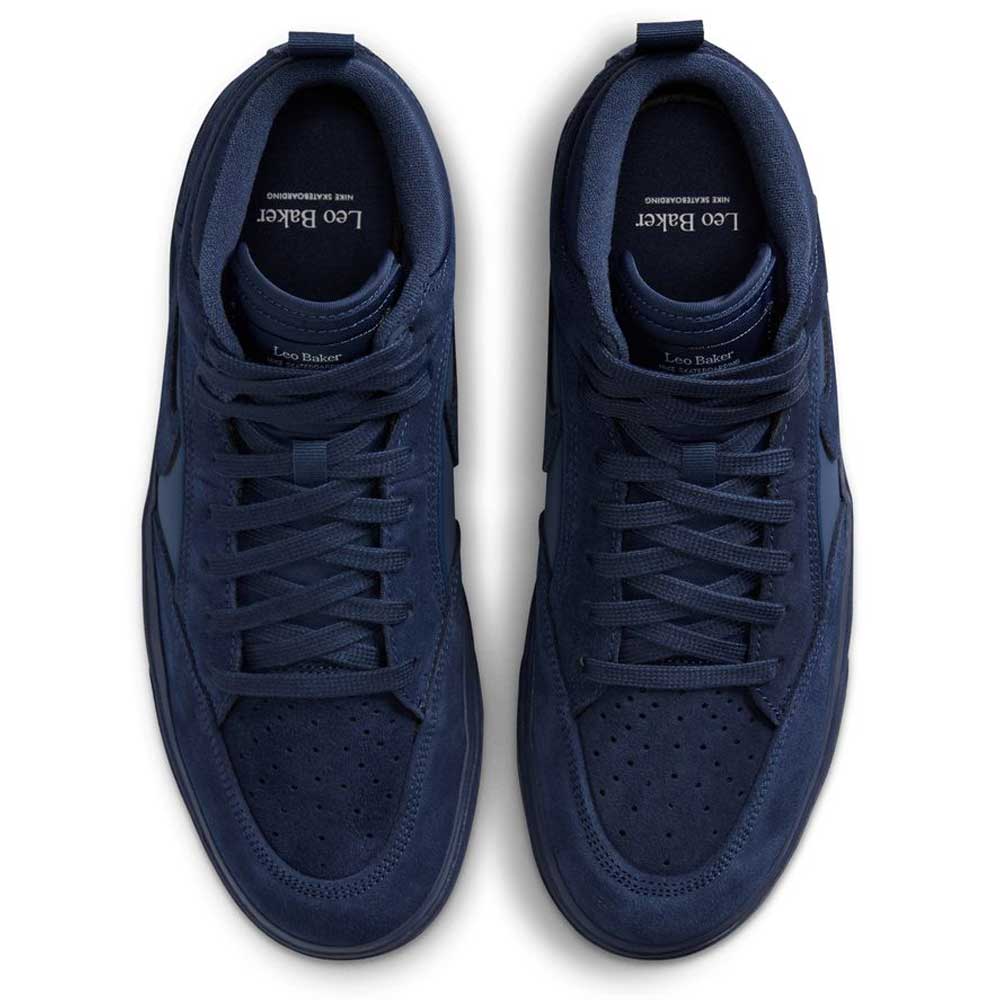A pair of Nike SB Leo Baker React Navy Black IR1889400 suede leather skateboarding shoes, viewed from above with laces, perforated toe boxes, and Leo Baker branding—designed for a pre-broken-in feel and durable traction.
