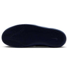 The image shows the navy black sole of the Nike SB Leo Baker React IR1889400 skateboarding shoe with a herringbone tread, photographed from below to highlight its durable traction against a white background.