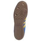 The image shows the sole of the Navy Yellow Gum Samba ADV HQ9283 Adidas Skateboarding Leather Suede Shoes, featuring a brown rubber tread with circular and diamond patterns, blue sides with yellow stripes, and the Adidas logo embossed on the sole.
