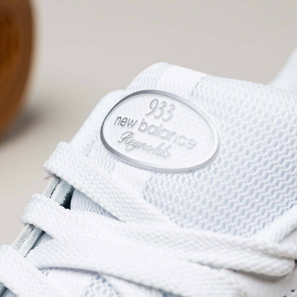 Close-up of the 933 WWB White Black Andrew Reynolds New Balance Numeric Suede Skateboarding Shoes, showing white laces, mesh texture, and a tongue label. Designed for premium cushioning and top skate performance.