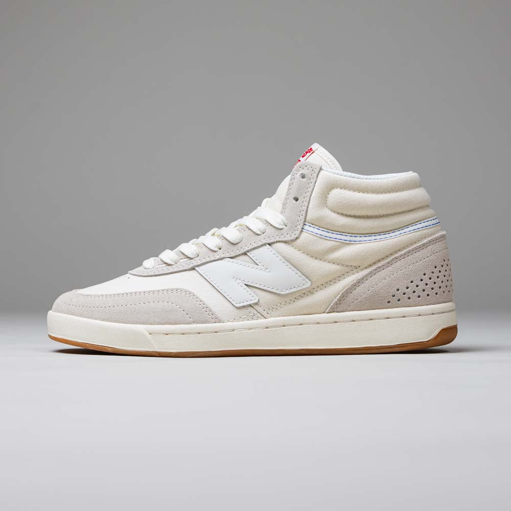 The 440 HTW Timberwolf White New Balance Numeric suede high-top skateboarding shoes feature a white N logo, perforated heel, ABZORB midsole, and gum sole, shown on a plain gray background.