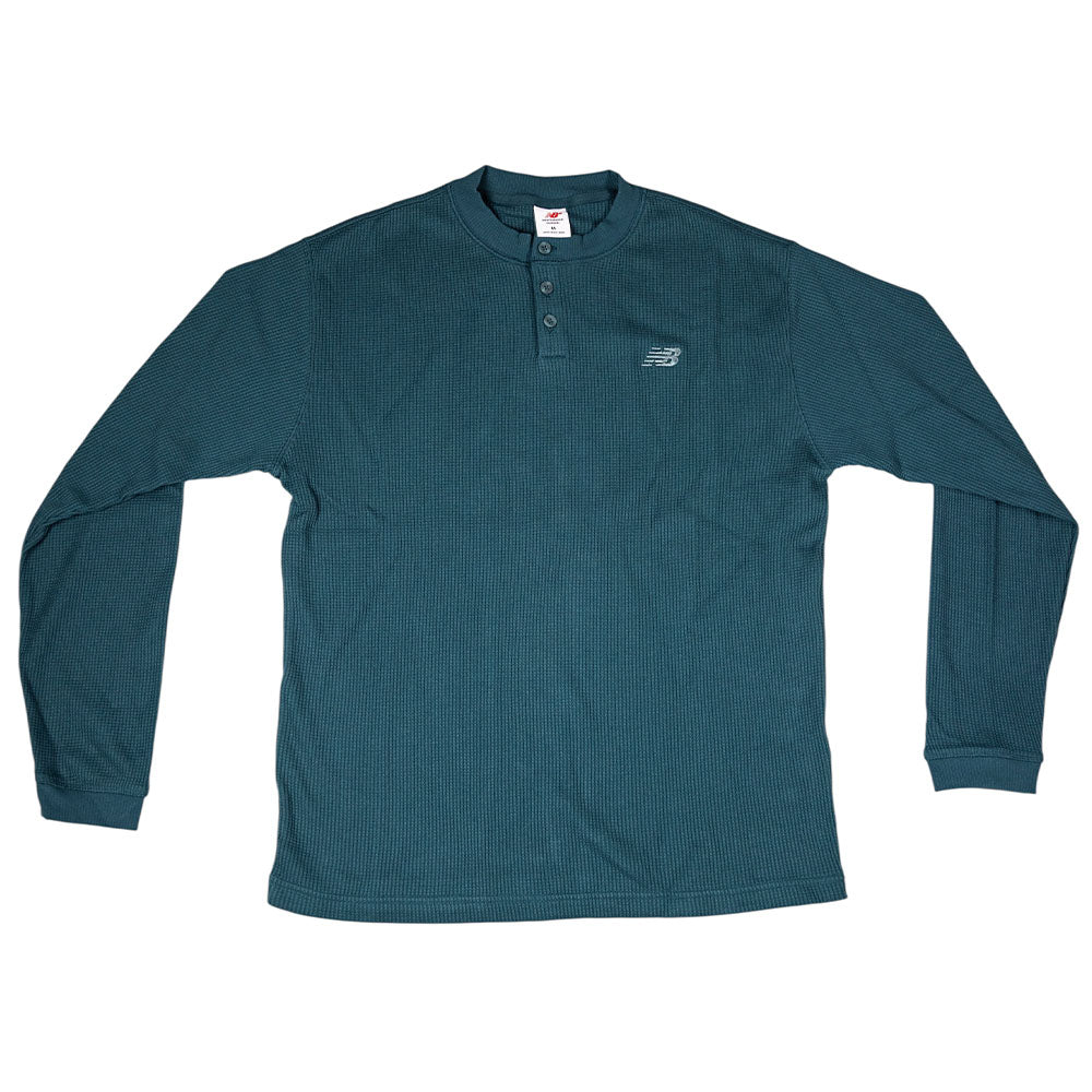 The New Balance Numeric Waffle Knit Tee MT51958AAV is a teal long sleeve waffle-knit Henley shirt with three collar buttons and a small embroidered logo on the left chest.