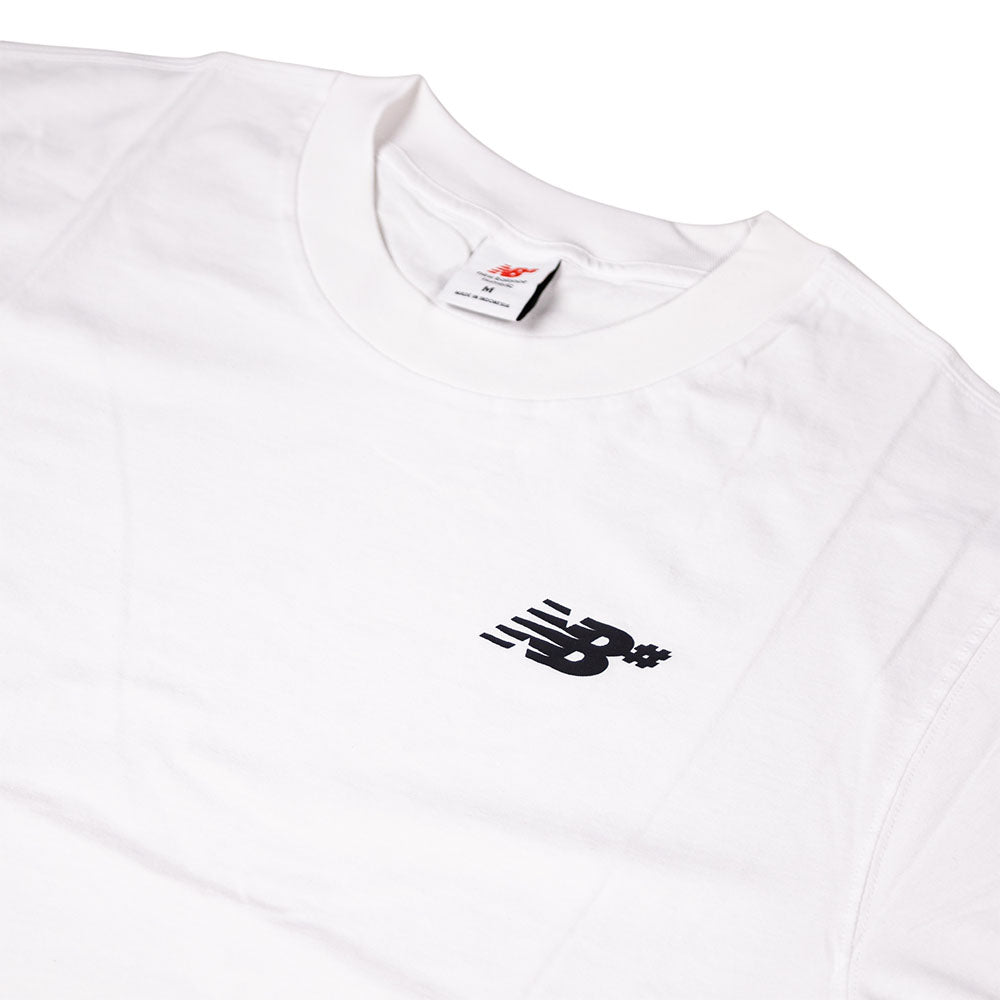 The New Balance Numeric Small Logo White Tee (MT53706WT) is a white cotton crewneck featuring a small black logo with motion lines on the left chest, a relaxed fit, and an internal collar tag.